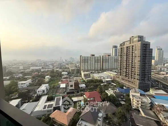 Stunning cityscape view from high-rise apartment balcony at sunrise.
