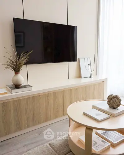 Modern living room with wall-mounted TV and stylish decor