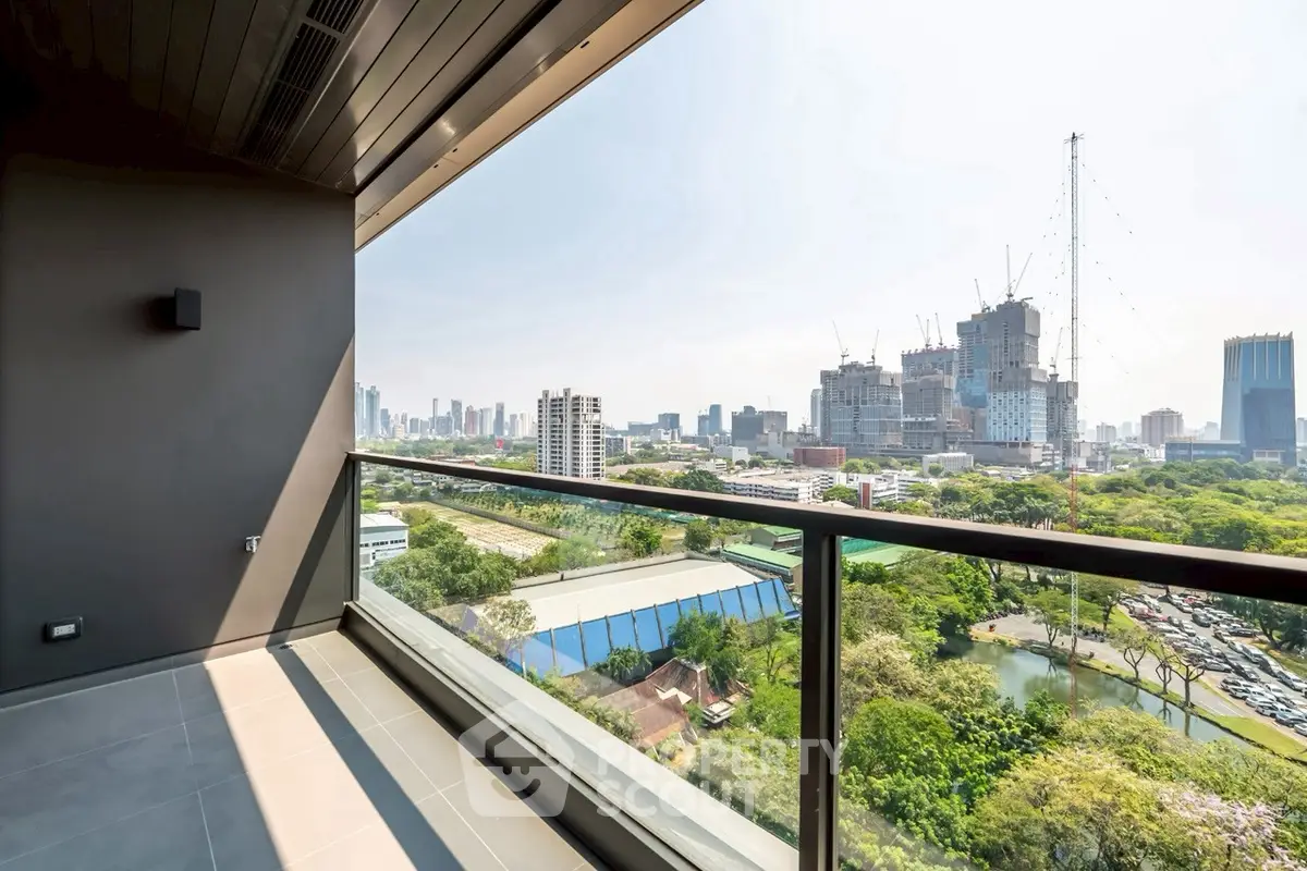 Stunning cityscape view from modern balcony with glass railing