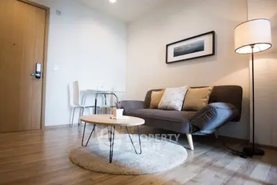 Modern living room with stylish sofa, round coffee table, and elegant floor lamp.