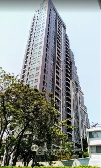 Stunning high-rise apartment building with modern architecture and lush surroundings.