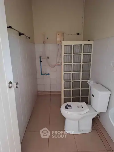 Spacious bathroom with modern fixtures and shower area