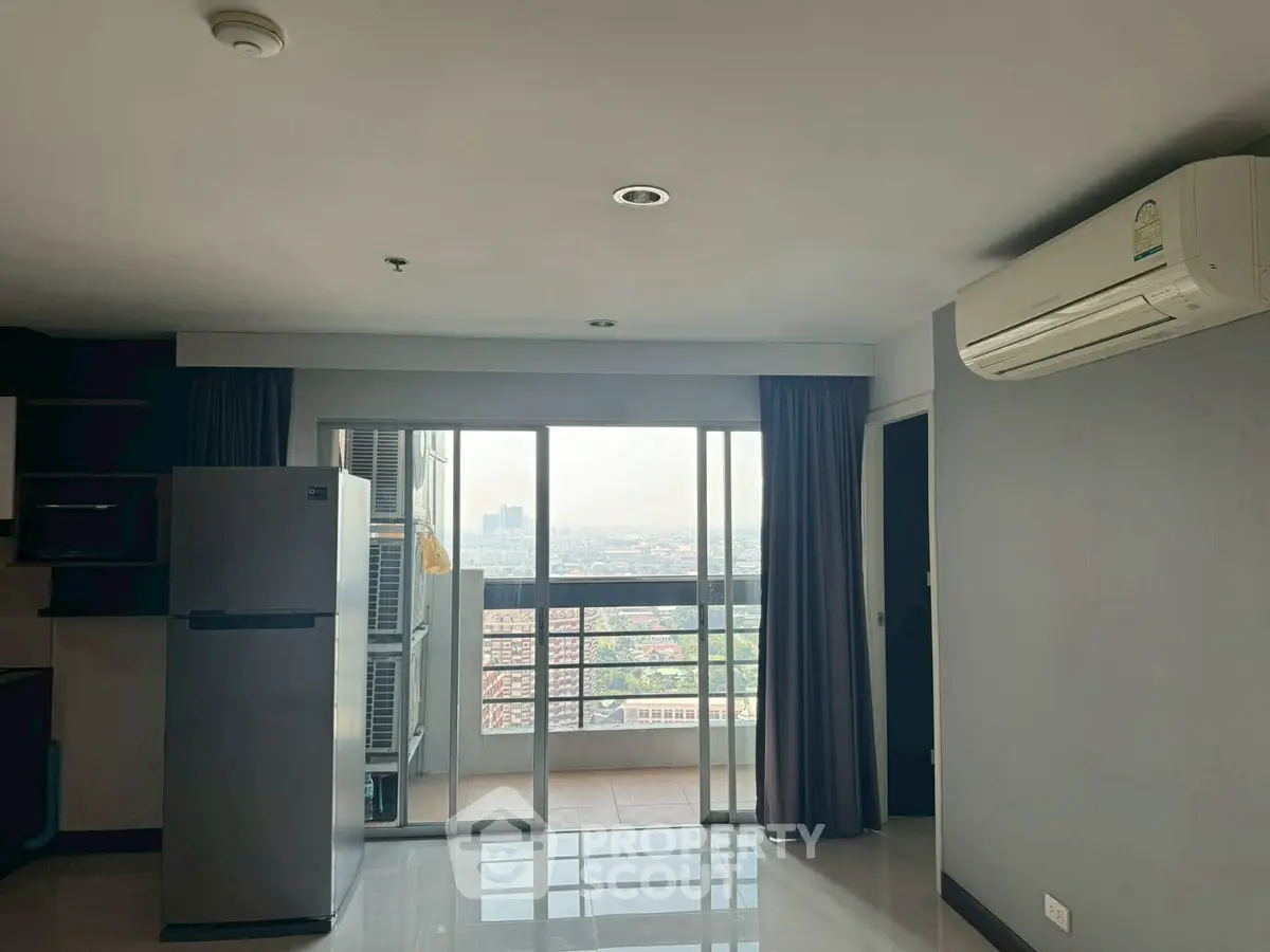 Modern apartment with balcony and city view, featuring air conditioning and sleek kitchen appliances.