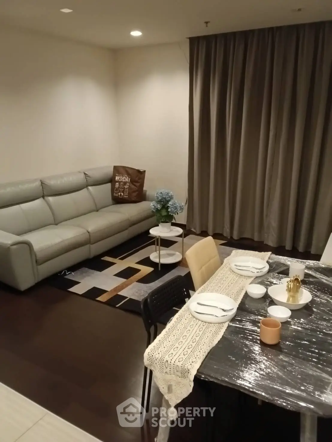 Modern living room with stylish decor and dining area in a cozy apartment setting.