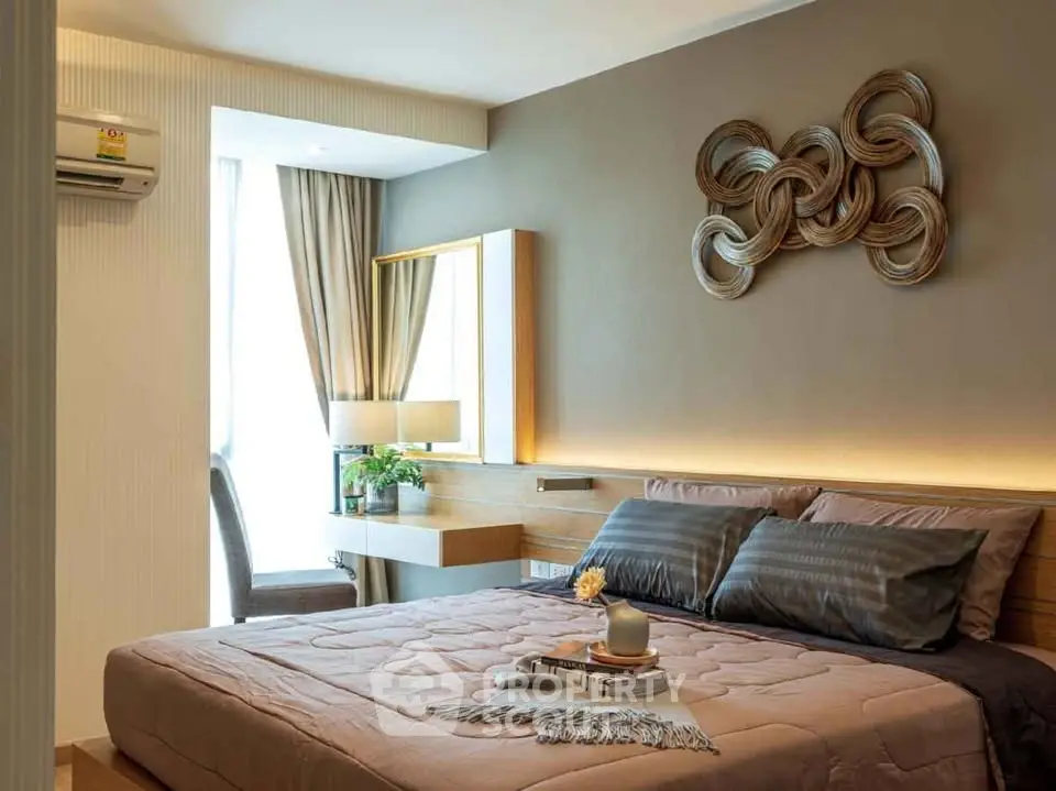 Elegant bedroom with modern decor and natural light, featuring a stylish wall art and cozy bedding.