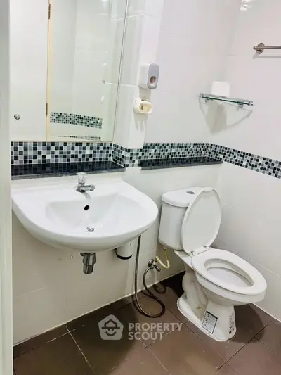 Modern bathroom with sleek fixtures and stylish tile accents, perfect for contemporary living.