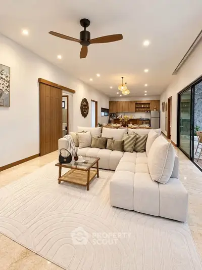 Spacious living room with modern decor and open kitchen layout