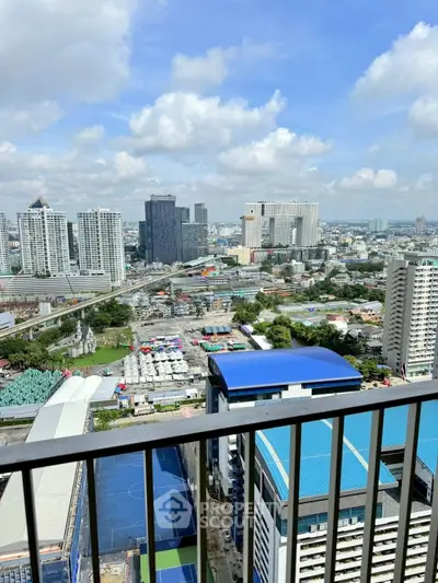 Stunning cityscape view from high-rise balcony with vibrant skyline and clear blue sky.