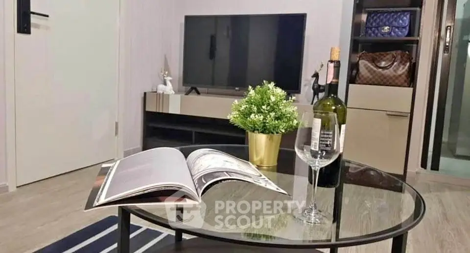 Stylish living room with modern decor, TV, and elegant coffee table setup.