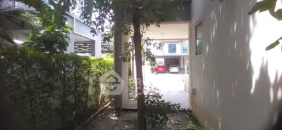 Charming garden pathway leading to modern residential parking area