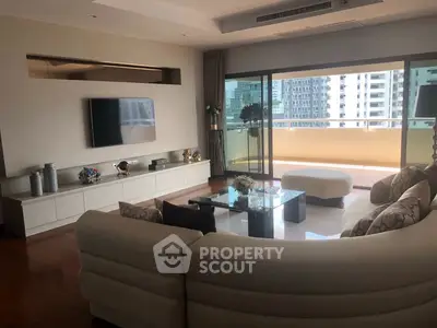 Spacious living room with modern decor and large balcony view in luxury apartment.