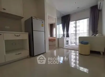 Modern apartment interior with open layout, featuring a cozy living area and balcony access.