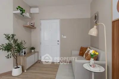 Cozy living room with modern decor, featuring a comfortable sofa, stylish lamp, and elegant wooden flooring.