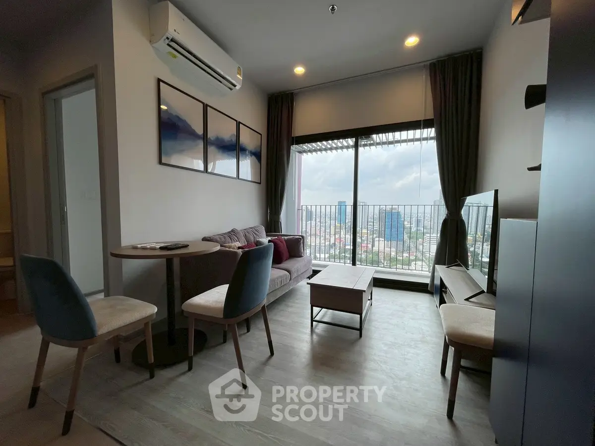 Modern living room with city view, stylish furniture, and large windows for natural light.