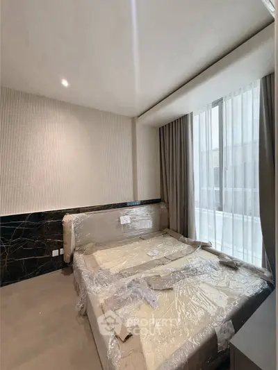 Modern bedroom with large window and elegant decor