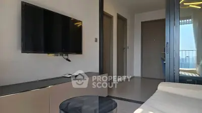 Modern living room with wall-mounted TV and balcony view
