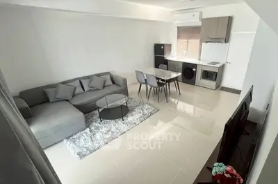 Modern living room with sleek furniture and open kitchen layout