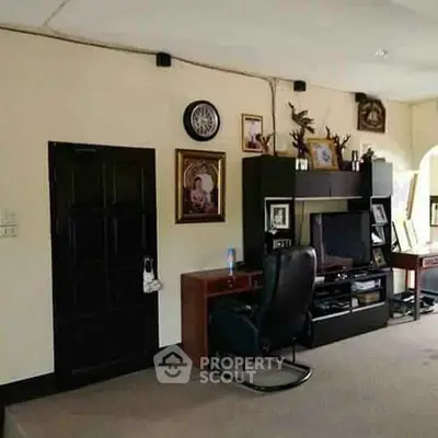Cozy living room with entertainment center and desk, ideal for relaxation and work.