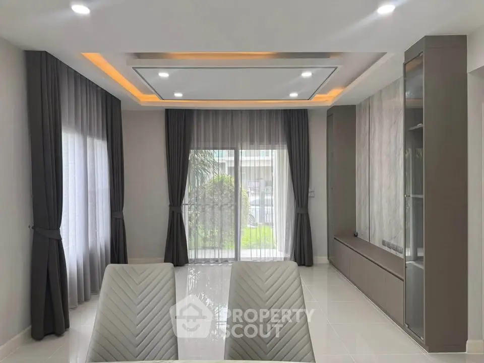 Modern living room with elegant curtains and recessed lighting