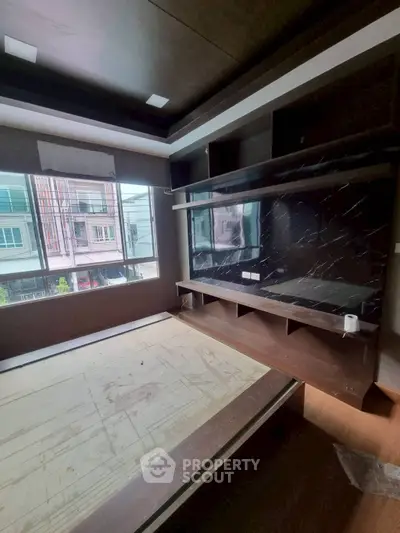 Modern bedroom with built-in storage and large window view