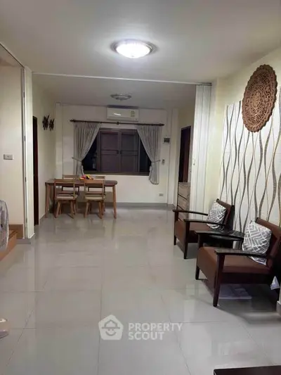 Spacious living room with modern decor and dining area, perfect for family gatherings.