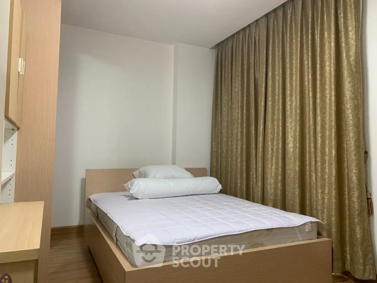 Cozy bedroom with modern wooden furniture and elegant gold curtains, perfect for restful nights.