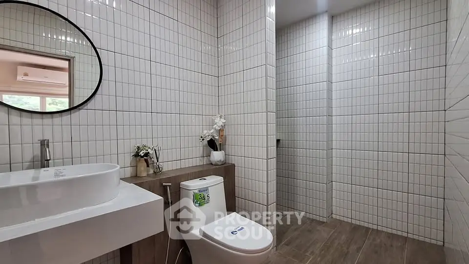 Modern bathroom with sleek white tiles and stylish fixtures