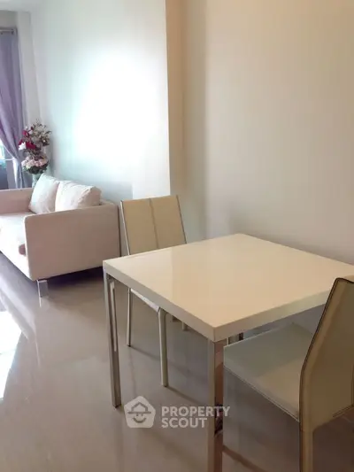 Modern living room with sleek dining area and cozy sofa, perfect for urban living.