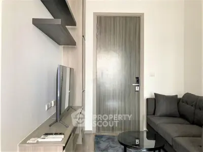 Modern living room with sleek furniture and wall-mounted TV, perfect for urban living.