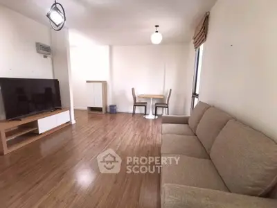 Spacious living room with modern furniture and wooden flooring