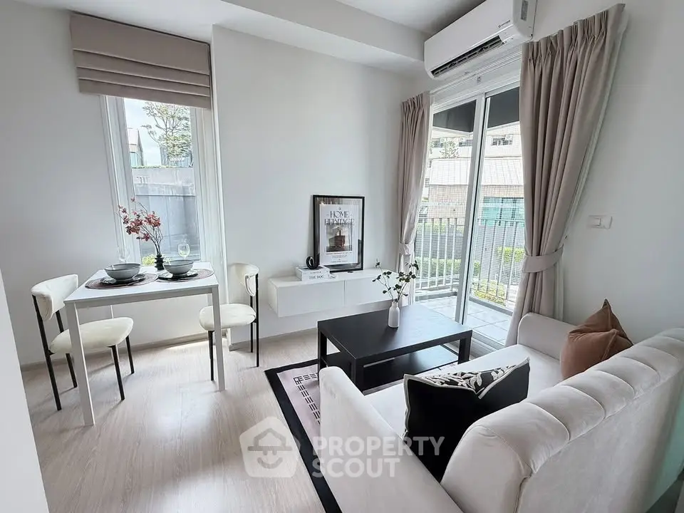 Chic modern living room with balcony access, featuring stylish decor and natural light.