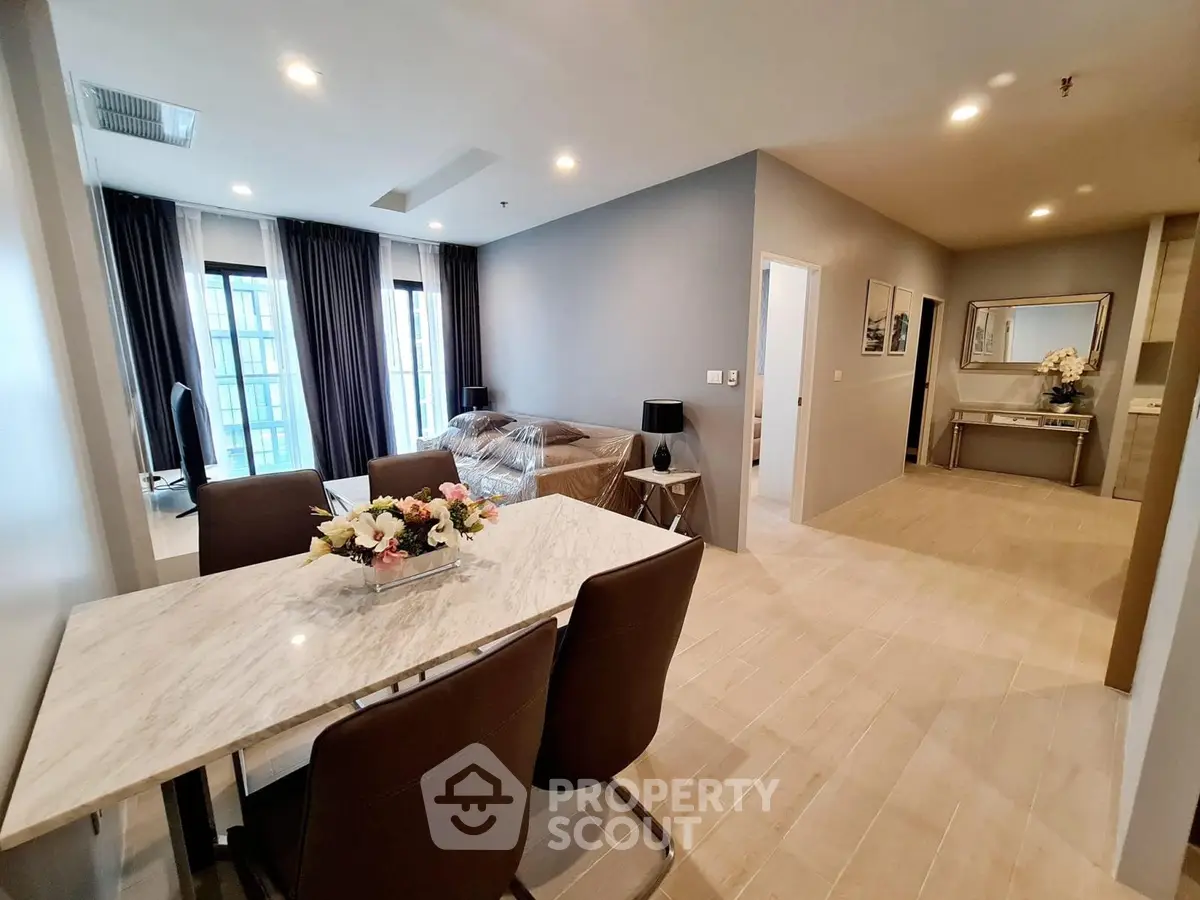 Spacious modern living room with dining area and elegant decor in a luxury apartment.