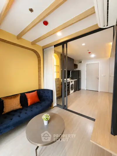 Modern living room with stylish decor and open kitchen layout in a cozy apartment.
