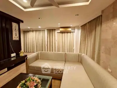 Spacious living room with elegant sofa and modern decor, perfect for relaxation and entertainment.
