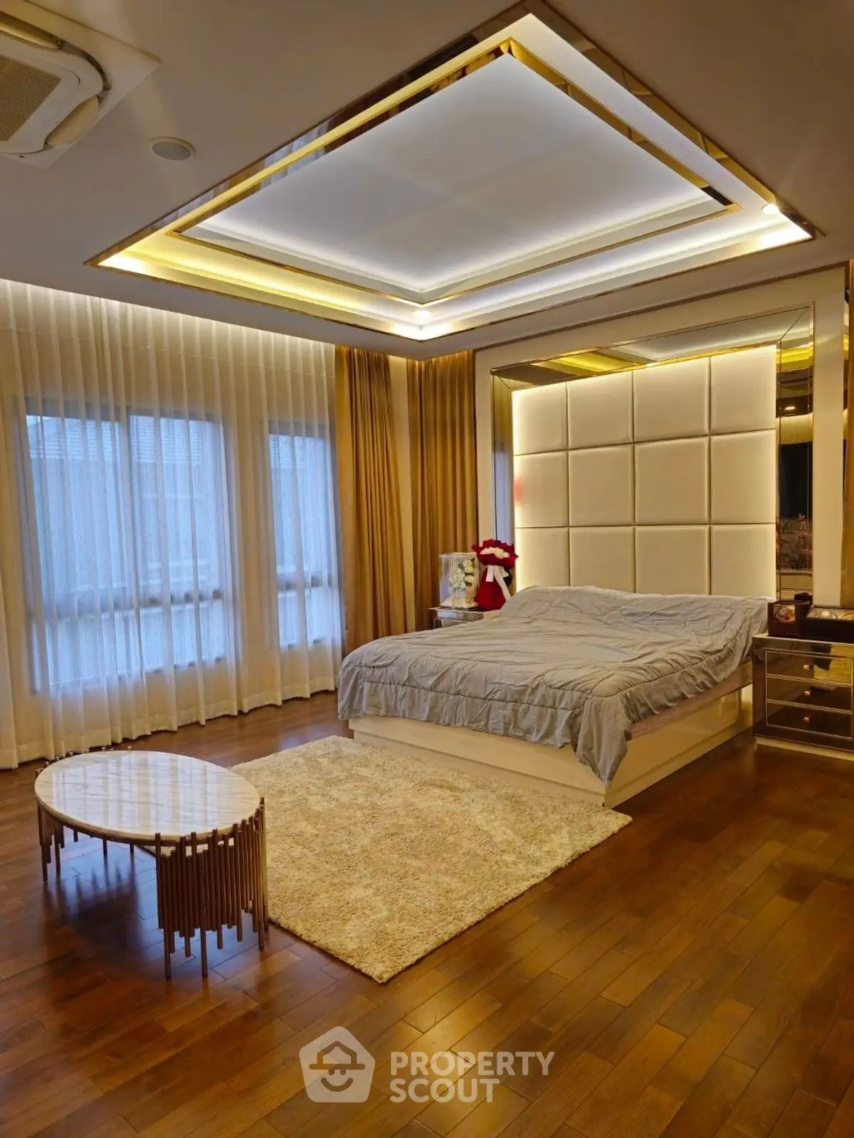Luxurious bedroom with elegant lighting and hardwood floors