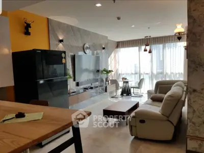 Spacious modern living room with large windows, stylish decor, and comfortable seating in a high-rise apartment.