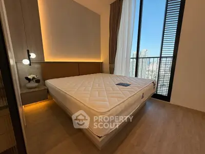 Modern bedroom with large window and city view, featuring a stylish bed and elegant decor.