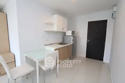 Modern compact kitchen with sleek design and dining area in a stylish apartment