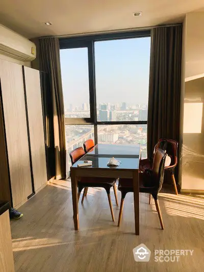 Sunlit high-rise study with panoramic city views, elegant wooden desk, and classic chairs, offering a serene workspace in a modern apartment.