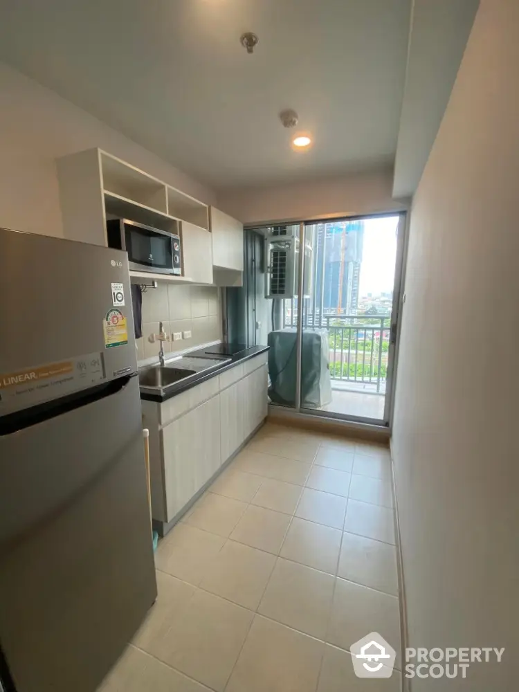 Modern kitchen with balcony view in high-rise apartment