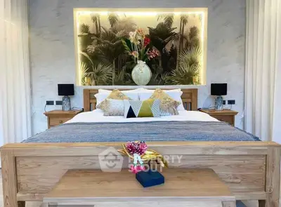 Luxurious bedroom with elegant decor and ambient lighting, featuring a stylish wooden bed and tropical-themed artwork.