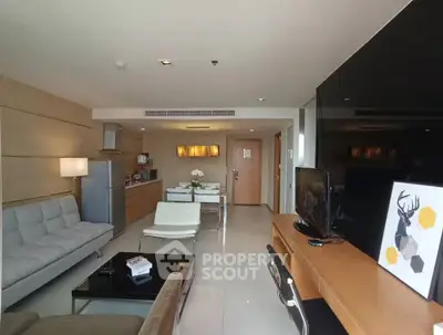 Modern living room with open kitchen and stylish decor in a contemporary apartment.