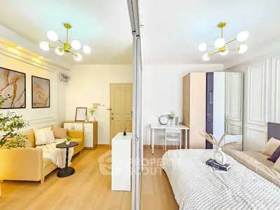Modern open-concept living room and bedroom with stylish decor and bright lighting