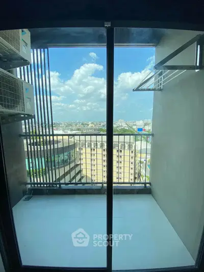 Stunning balcony view from high-rise apartment with cityscape and blue sky.