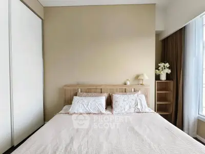 Spacious bedroom with elegant decor and natural light