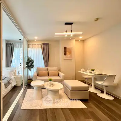 Modern living room with stylish furniture and open layout, featuring a cozy seating area and dining space.