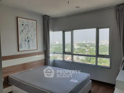Spacious bedroom with panoramic city view and modern decor
