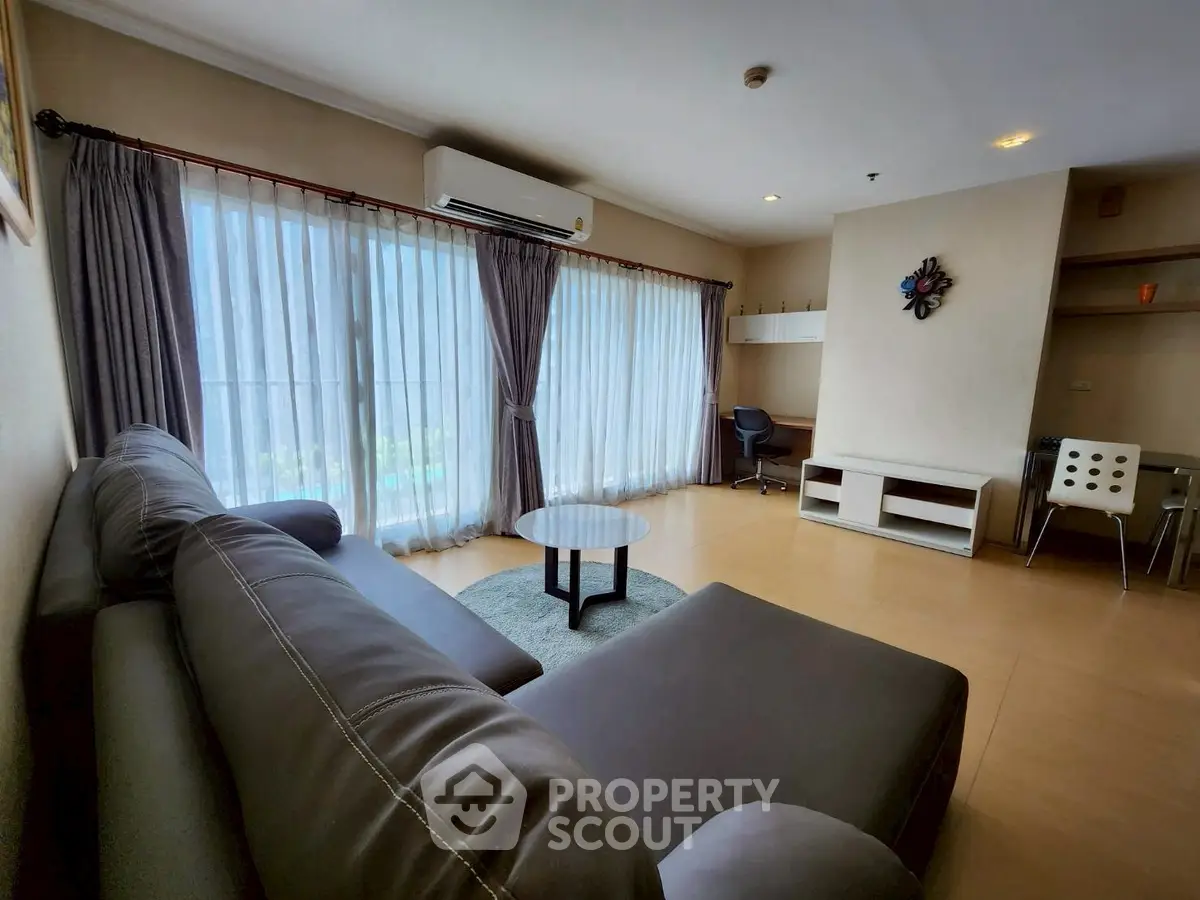 Spacious living room with modern furniture and large windows