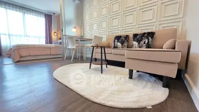 Modern open-plan living room with stylish decor and cozy bedroom area