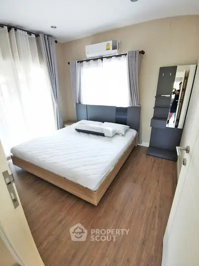 Spacious bedroom with modern decor and natural light